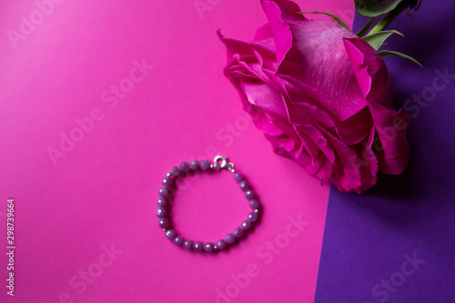 The hand bracelet with decor on pink background.