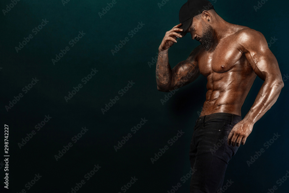 Fototapeta premium Strong and fit man bodybuilder. Sporty muscular guy athlete. Sport and fitness concept. Men's fashion.