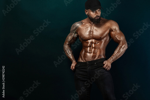 Strong and fit man bodybuilder. Sporty muscular guy athlete. Sport and fitness concept. Men's fashion.