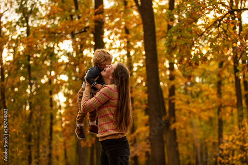 Happy mom is circling with her beautiful baby in the autumn park. Lifestyle. Happy emotions. © nick_fedirko