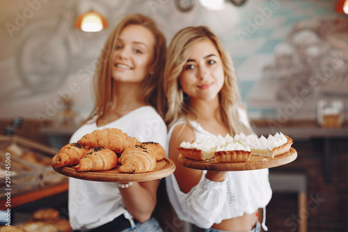 Girls at the bakery. Ladies with cake. Blonde in a white shirt