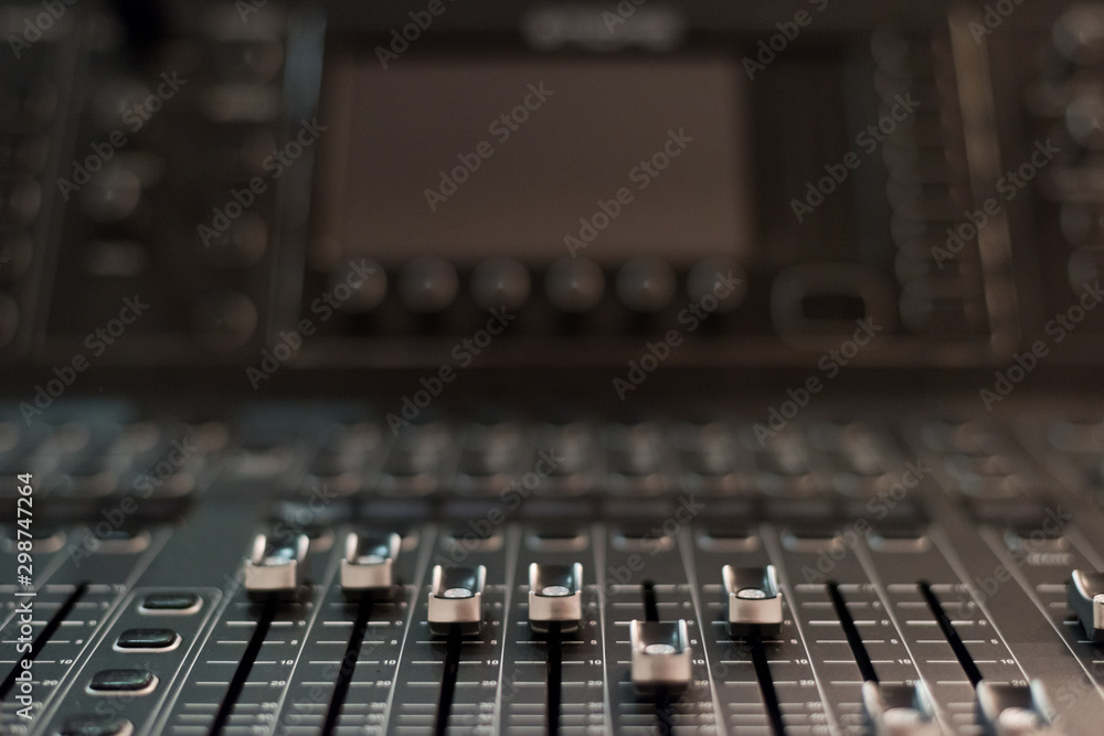 Audio sound mixer console. Audio mixer, music equipment. broadcasting tools, mixer, synthesizer. and computer control.Professional sound and audio mixer control panel with buttons and sliders.