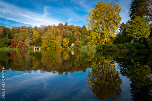 Autumn trees reflected in lake at Stourhead