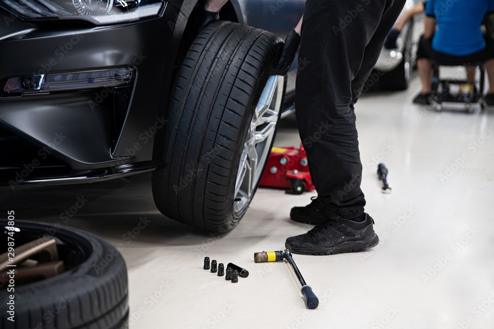 Mechanic changing wheel and tire. Car service