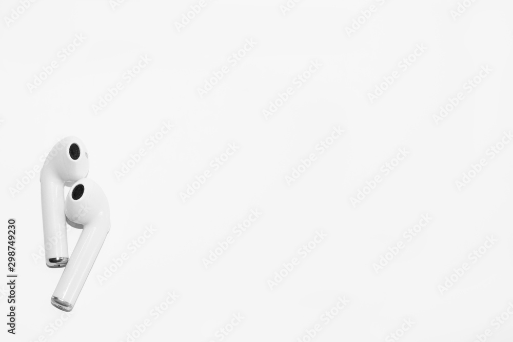 A pair of modern wireless headphones on a white background, space for lettering. A pair of modern wireless headphones on a white background, space for lettering.