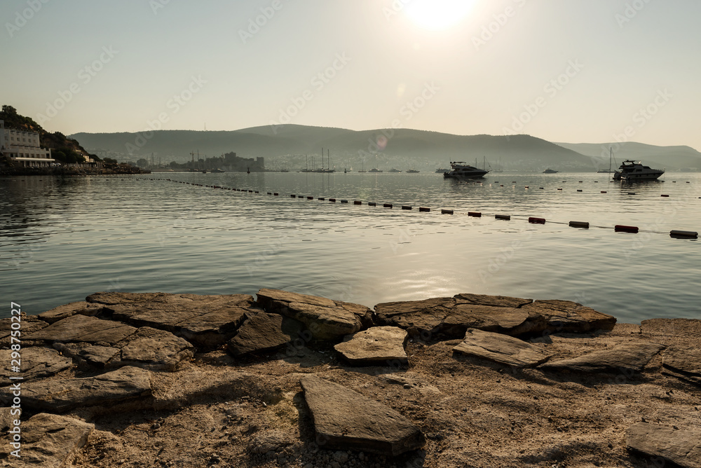 Panoramic Sunrise view of Bodrum Castle and marina bay on Turkish Riviera from old wooden docks. Bodrum is a district and a port city in Mugla Province, in Aegean Region of Turkey