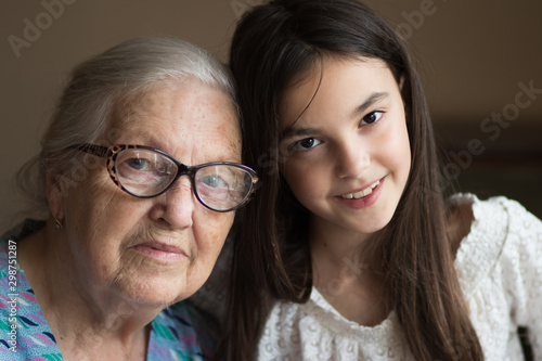 background. portrait. grandmother helps her beloved granddaughter to do homework.