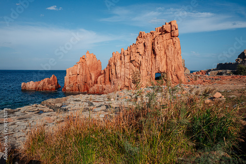 Fototapeta Naklejka Na Ścianę i Meble -  ARBATAX, ITALY / OCTOBER 2019: The scenic red rocks beach in Sardinia, Ogliastra region