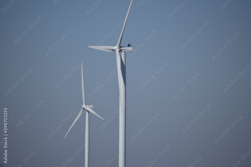 Fototapeta premium closeup of wind turbine against blue sky