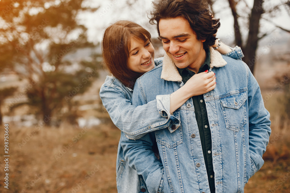 Fototapeta premium gentle and stylish couple are having a walk in the autumn park