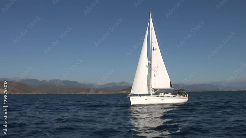 Sea, mountains, summer and white yachts.Yachting as an active lifestyle. concept of water transport, travel and recreation. Sailing boat in regatta. Concept of summer and yachts, water transport. Sea, mountains, summer and white yachts.Yachting as an active lifestyle. concept of water transport, travel and recreation. Sailing boat in regatta. Concept of summer and yachts, water transport.