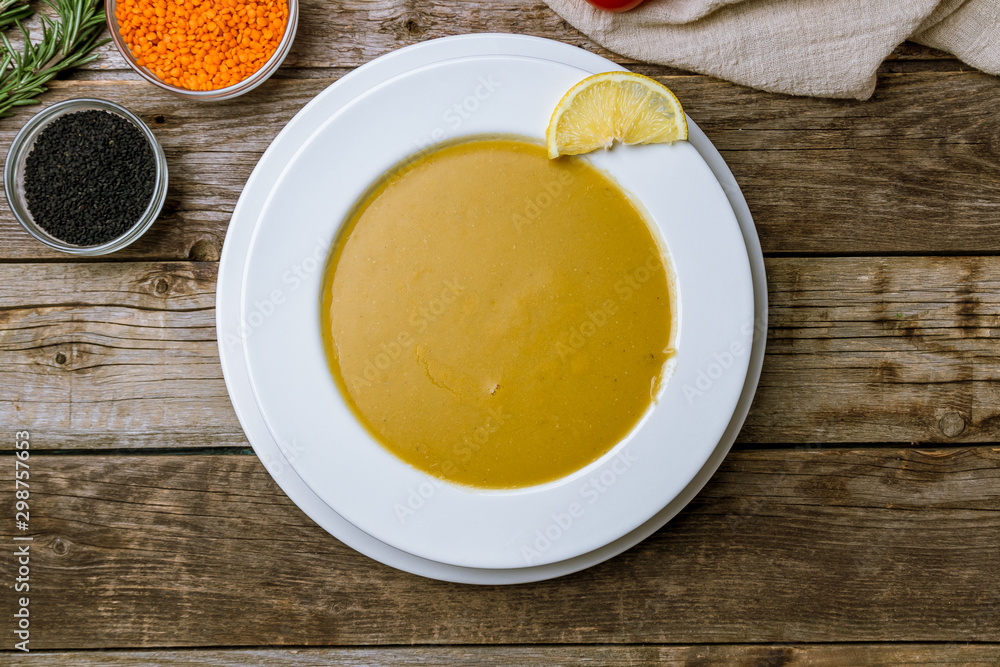 Lentil soup with lemon on wooden table. Turkish cuisine Lentil soup with lemon on wooden table. Turkish cuisine