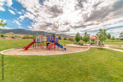 Fun childrens playground with amazing view of cloudy blue sky and mountain