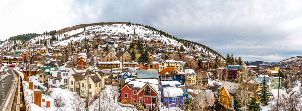 Colorful mountain homes in Park City Utah with cloudy sky background in winter - obrazy, fototapety, plakaty 