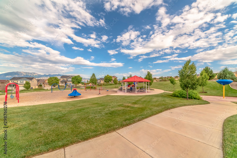 Playground and picnic pavilion at a park with view of distant Mount Timpanogos