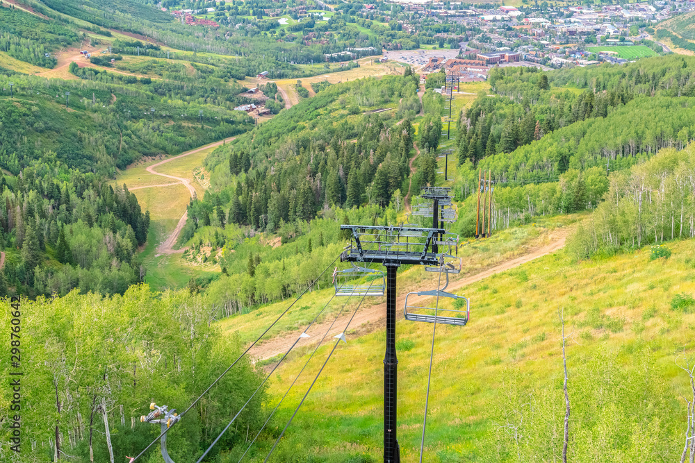Chairlifts with amazing view of ski resort blanketed in greenery at off season