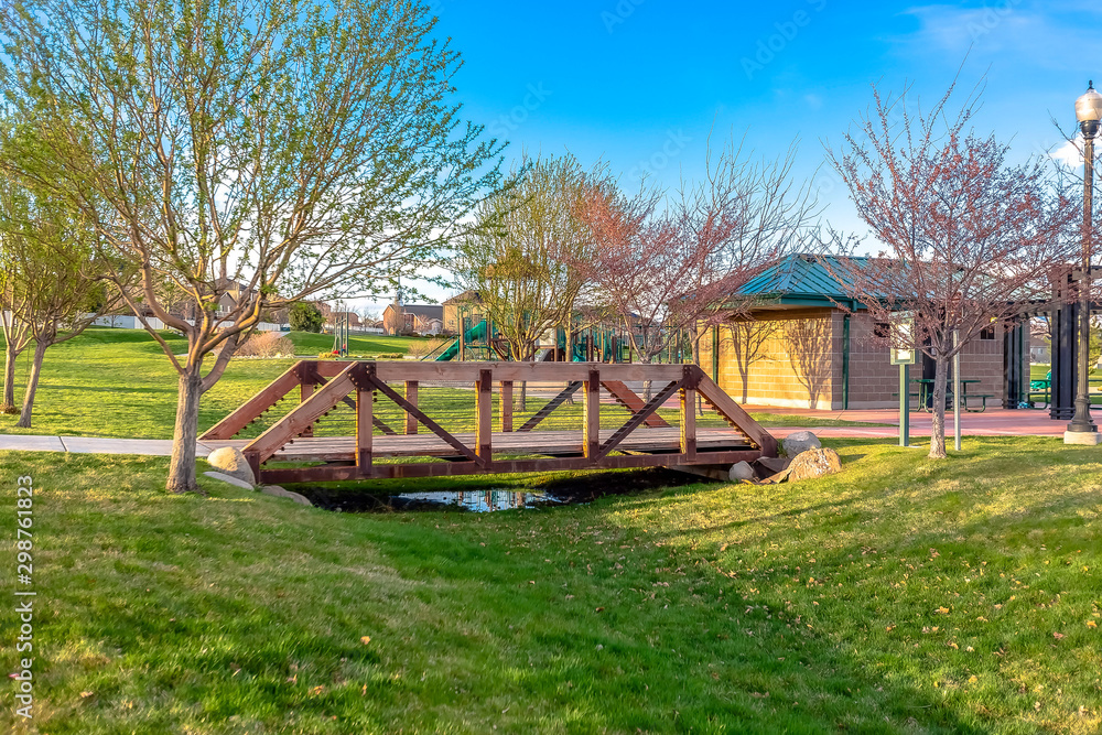 Rustic wooden bridge crossing a stream with no water Rustic wooden bridge crossing a stream with no water