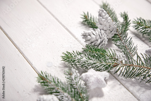 Christmas card - Christmas tree branches on the wooden background