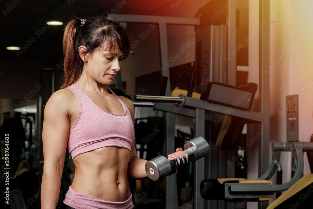 Fototapeta premium Fitness Woman In Training. Strong Abs Showing