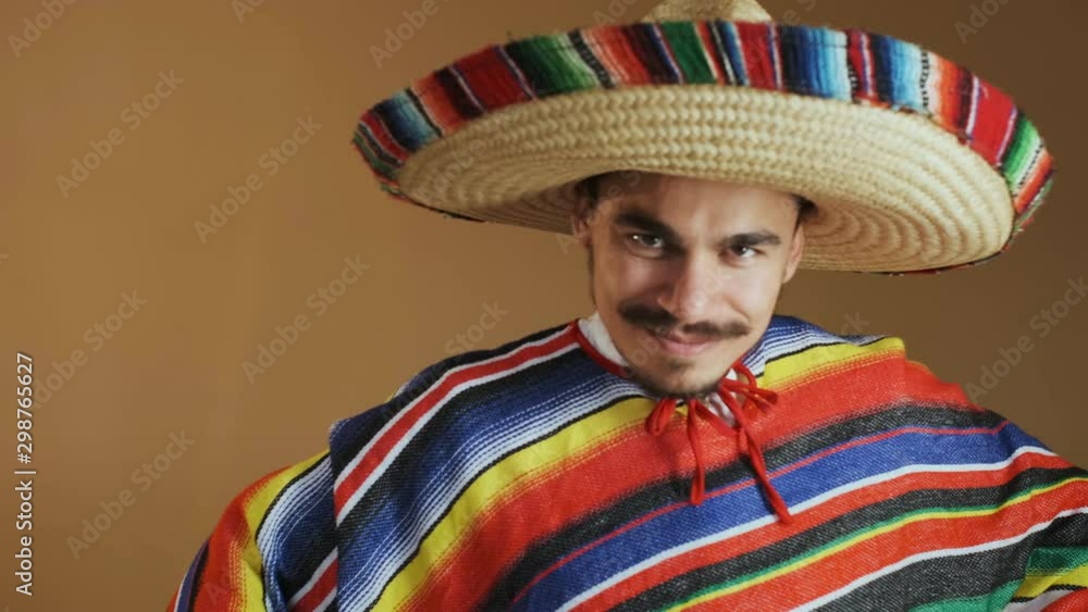 Young Mexican In Multicolored Poncho And Hat. Young Mexican In Multicolored Poncho And Hat.