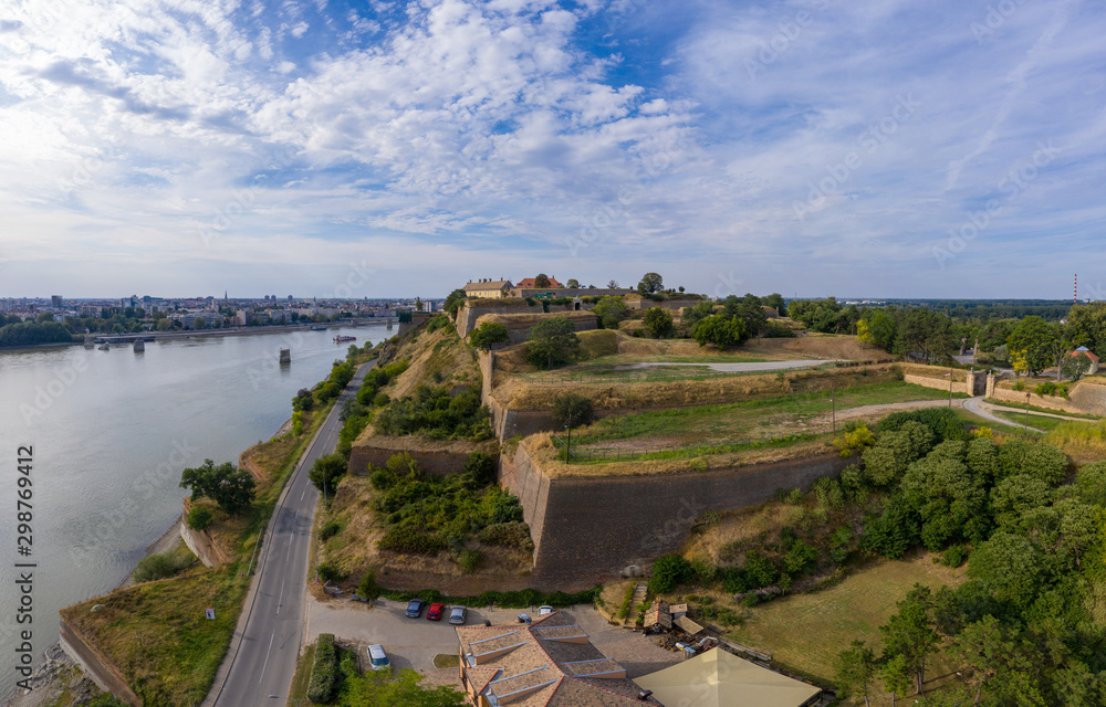Aerial panorama view of Petrovaradin fortress trdava above the Danube River across from Novi Sad Serbia with lot of detail of the walls, ramparts and moats and blue sky Aerial panorama view of Petrovaradin fortress trdava above the Danube River across from Novi Sad Serbia with lot of detail of the walls, ramparts and moats and blue sky