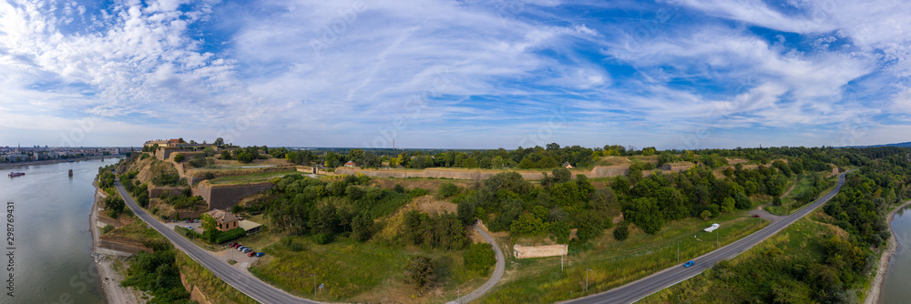 Aerial panorama view of Petrovaradin fortress trdava above the Danube River across from Novi Sad Serbia with lot of detail of the walls, ramparts and moats and blue sky