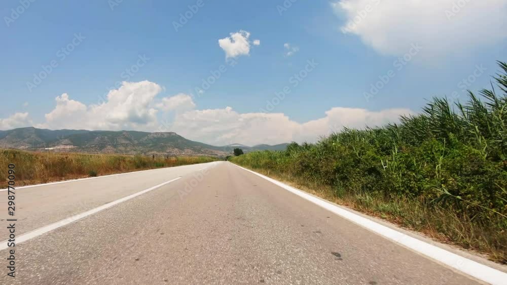 POV, Driving Plate - car driving on a straight countryside road in Greece on a sunny summer day. POV, Driving Plate - car driving on a straight countryside road in Greece on a sunny summer day.