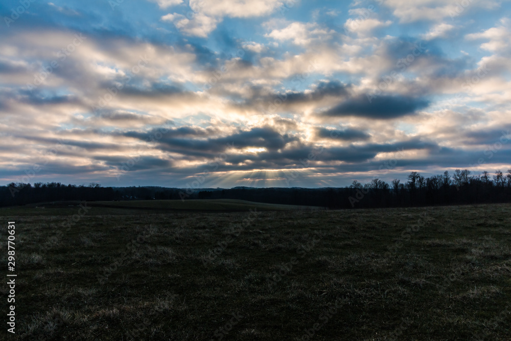 sunset over green field