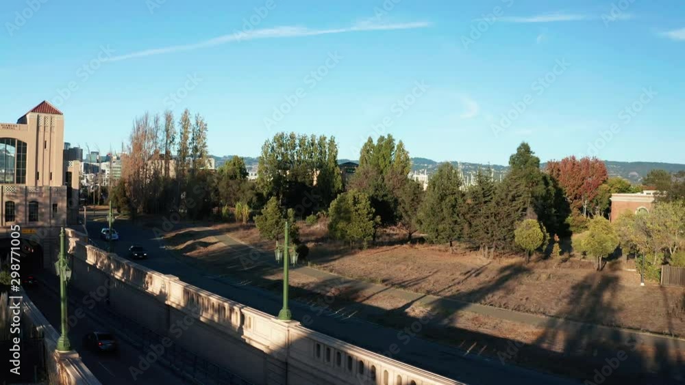 Trees and a city reveal with large traffic tunnel in the afternoon. Trees and a city reveal with large traffic tunnel in the afternoon.