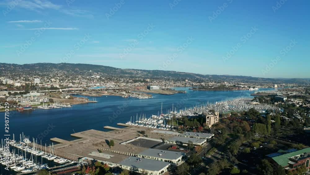 An urban marina with sailboats and luxurious water near retirement real estate on the bay. An urban marina with sailboats and luxurious water near retirement real estate on the bay.