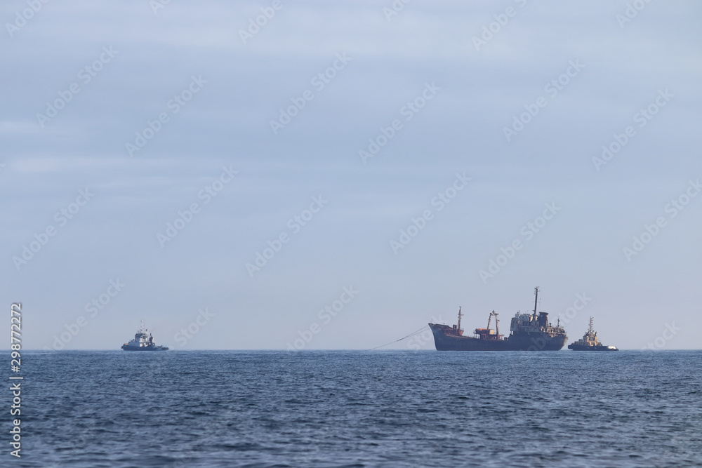 Tugboats towing the old rusty wreck ship for ship breaking. Tugboats towing the old rusty wreck ship for ship breaking.