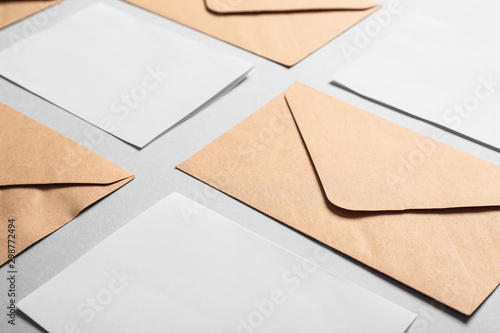 Mockups of invitations with envelopes on light background