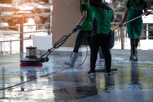 the worker cleaning  floor walkway with using polishing machine and chemical or acid