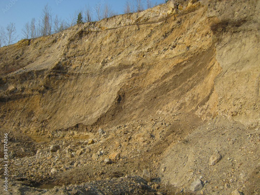 Photo of the quarry for the extraction of gold. A large pile of rubble sand and clay saturated with gold. Photo of the quarry for the extraction of gold. A large pile of rubble sand and clay saturated with gold.