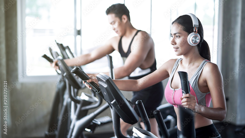 Fototapeta premium Young asia people run on a treadmill in the gym.