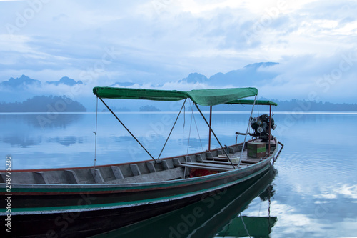 Long tail boat in the early morning at Cheow Larn Lake   Khao Sok National Park  Surat Thani Thailand