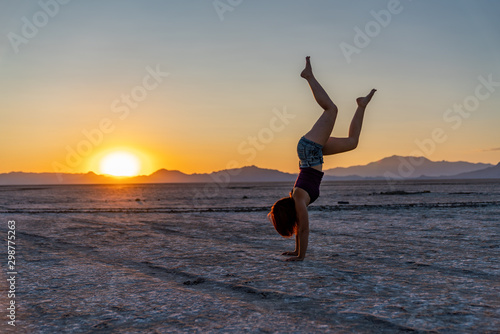 Beautiful Woman Doing Handstands In The Bonneville Salt Flats photo