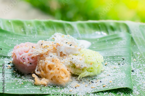 Thai Desserts (Ka-Nhom-Ray-Rai or Rang-rai ), Rice flour dumpling topped coconut milk and sugar mixed with sesame, colorful Thai desserts, Thailand traditional food. photo