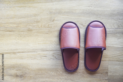 Brown slippers on the wooden floor / home slippers