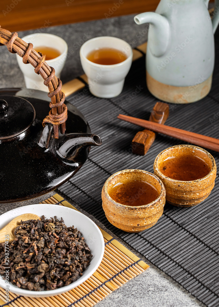 Hot tea in glass teapot and cup with steam Hot tea in glass teapot and cup with steam