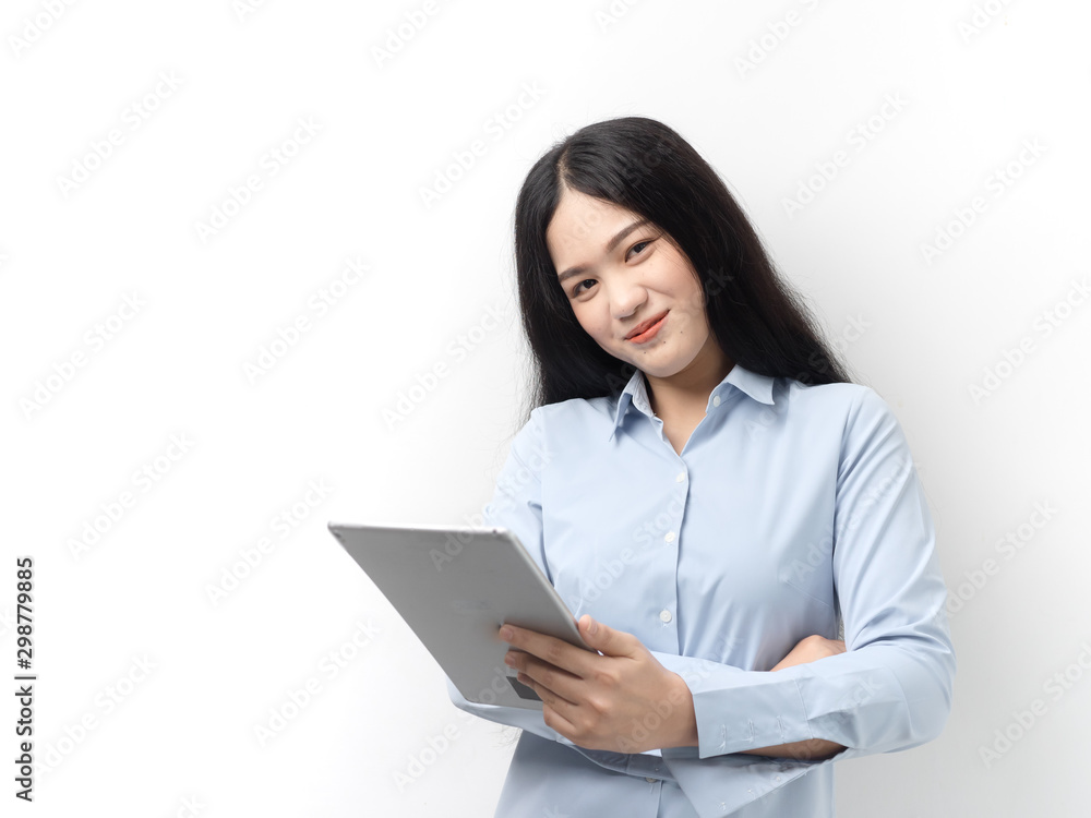 Happy Asian woman in blue shirt using tablet on white background Happy Asian woman in blue shirt using tablet on white background