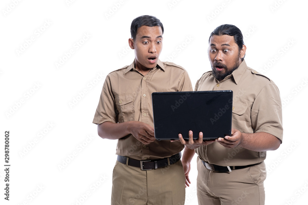 portrait of shocked and suprised worker while looking at laptop together