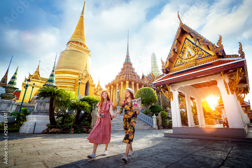 Asian girl walk in Wat phra kaew and grand palace travel in Bangkok city photo