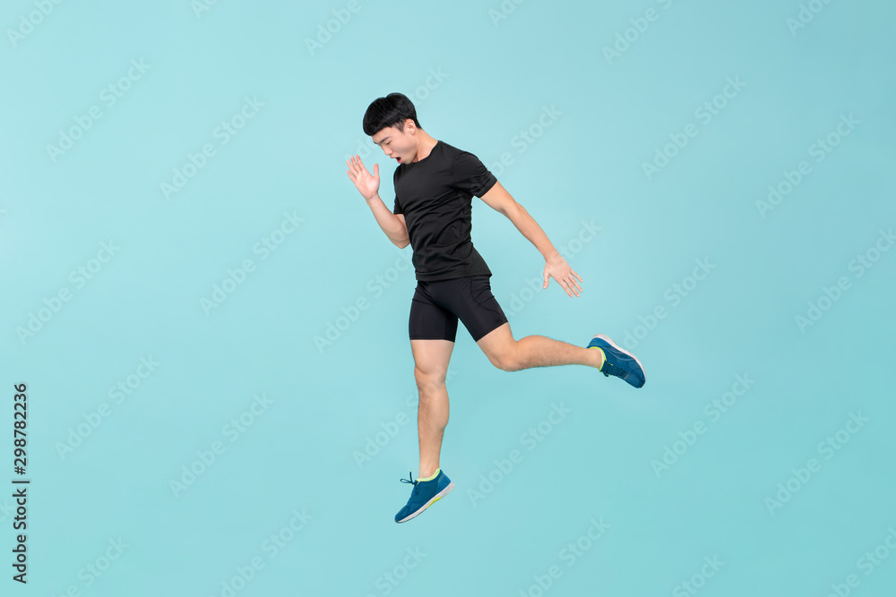 Full body of energetic young athlete Asian man jumping