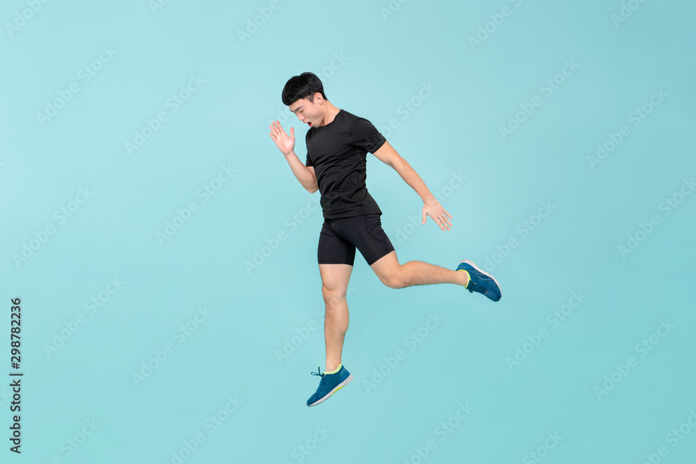 Full body of energetic young athlete Asian man jumping Full body of energetic young athlete Asian man jumping