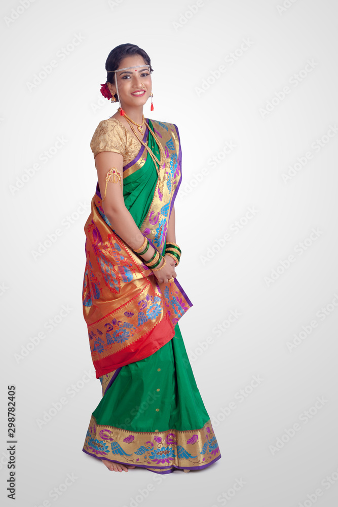 Beautiful Indian marathi bride in traditional Green navwari Saree.Bride looks beautiful in white background.