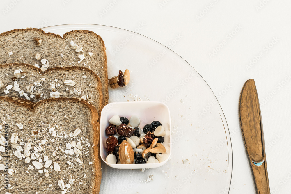 Healthy bread and seeds snack on a transparent plante over white background Healthy bread and seeds snack on a transparent plante over white background
