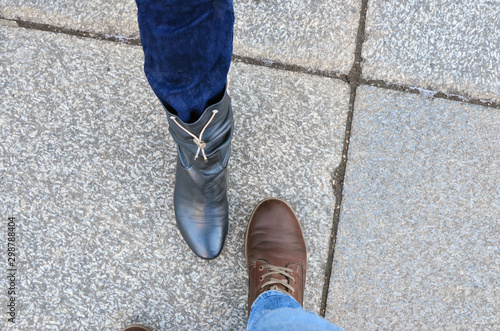 Two female legs in jeans and leather shoes