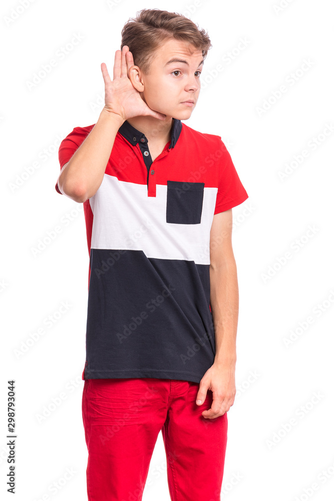 Portrait of teen boy holds his hand near his ear and listening something, isolated on white background. Cute caucasian young teenager overhears, listening an hearing to rumor or gossip. Portrait of teen boy holds his hand near his ear and listening something, isolated on white background. Cute caucasian young teenager overhears, listening an hearing to rumor or gossip.