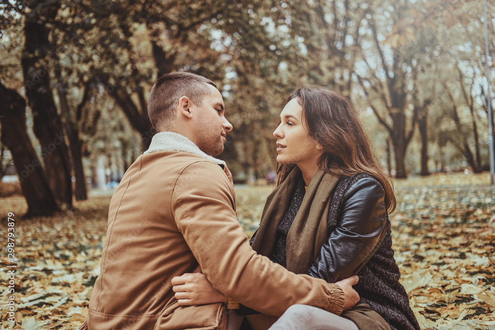 Beautiful couple has a date at autumn park full of yellow maple leaves. Beautiful couple has a date at autumn park full of yellow maple leaves.